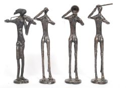 A group of four cast metal band figures to include  conductor, violinist and other band members.