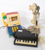 A vintage late 20th century polished steel stick telephone together with a novelty telephone in the