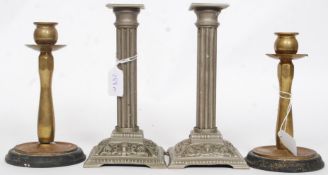 A good pair of early 20th century brass candlesticks with wooden plinth bases together with a