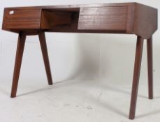 A stunning 1960's Danish teak writing table desk. Of angular form raised on tapered supports.