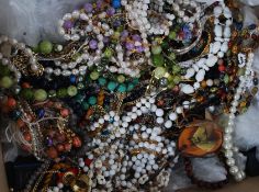 A box of costume jewellery to include many items - brooches, bangles,
