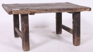 A Chinese pine opium - tea table of rustic form raised on sqaured legs with planked top