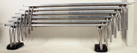A set of six metamorphic folding stacking school benches complete with castors for easy movement (
