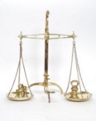 A good pair of Victorian brass weighing scales, with shaped tripod base.