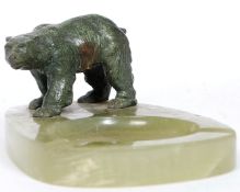 A 1920's Art Deco hardstone - agate ashtray having recess flanked by bronze model of a polar bear