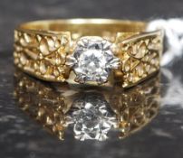 An 18t gold and diamond ladies gypsy ring having a fret worked shank with inset diamond approx