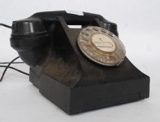 A vintage 1950's style bakelite telephone from Portugal having date to stamp to the base for 1964