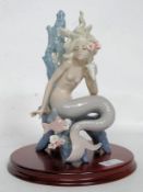 A vintage Lladro Ocean Beauty figurine raised on a mahogany plinth base.