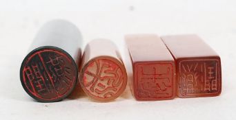 A small collection of Chinese hardstone chop seals, each with character marks to the base.