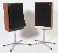 A pair of retro Mordant Short Festival 2 speakers raised on a pair of quadrabased chrome floor