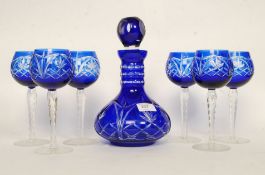 A 20th century Bohemian blue flash cut glass decanter and goblet set.