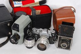 A good vintage Zenit SLR camera together with a collection of lenses and accessories in leather