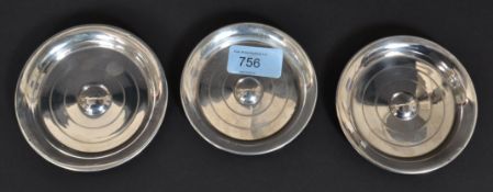 A set of 3 graduating silver hallmarked peanut dishes of circular form being engine turned.