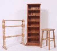 A pine upright open window bookcase cabinet together with a pine Victorian style towel rail and a
