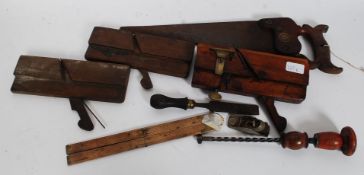 A collection of vintage woodworking tools to include an Holbrook plane along with other planes and