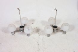 A pair of retro mid century three branch chandelier light fittings, having frosted glass shades.