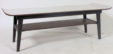 A good 1970's retro melamine topped surfboard style coffee table raised on angular legs.