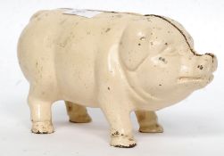 A vintage Cast Iron 20th century painted money box in the form of a pig.