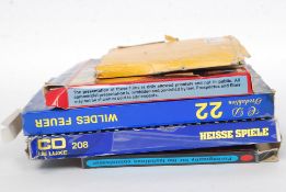 A collection of vintage 8mm adult pornographic films, each within the original box.