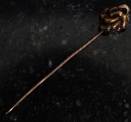 A 19th century 9ct gold Victorian hat pin. The pin with a scrolled knot.
