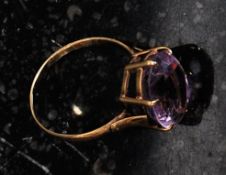 A 9ct gold dress ring set with a large amethyst.  Weight 3.1g.