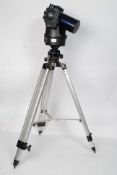 A Meade ETX - 90 EC telescope mounted on purpose made chrome tripod stand along with an aluminium