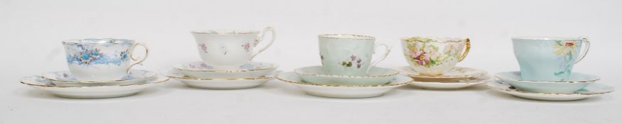 A collection of 5 chintz pattern china trios to include examples by Moore, Paragon,