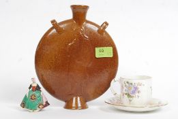 An early 20th century salt glazed stoneware moon flask with religious figures together with a Royal