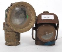 A vintage ARP hand held black out lamp together with a good motorcycle Lucas lamp