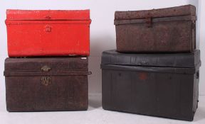 A stack of early 20th century vintage metal trunks to include graduating sizes,