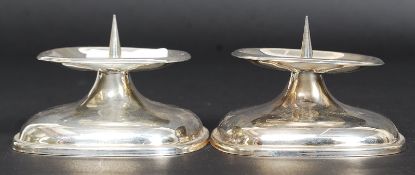 A pair of mid century WMF stamped silver plated candlesticks of stub form having prickers to centre.