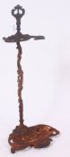 A Victorian cast iron coalbrookdale style umbrella stand with unusual open topped supports on a