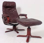 A retro Ekorness style Ox blood leather reclining swivel chair with matching footstool
