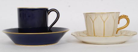 A Royal Worcester Ivory blush teacup and saucer with gilded decoration together with a Sevres 1906