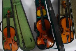 A group of three cased Violins to include two Chinese and another,