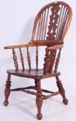 A Victorian yew wood and elm country windsor armchair.