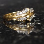 An 18ct gold diamond of unusual cross over form, the stones being pave set. Total weight 4.