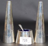 A contemporary silver plated condiments - salt and pepper pots together with a blue glass lined