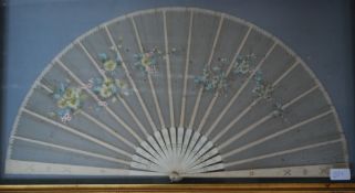 A 1920's Japanese ivory and lace work ladies fan of decorative form being spread open and framed in
