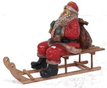 A resin ex shop window display Father Christmas and sleigh display decoration figure.