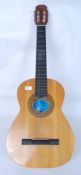 A Spanish six string acoustic guitar with three music books of which two are for folk music