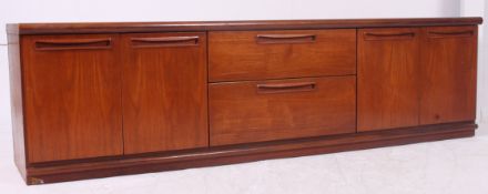 A Danish style teak wood effect low sideboard, having three drawers flanked by cupboards.