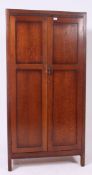 A 1930's oak wardrobe having full length panel doors, having a fully appointed interior.