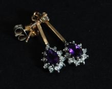 A pair of 9ct gold, diamond and amethyst ladies earrings of tear drop form.