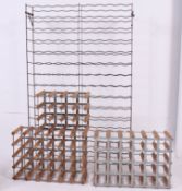 A group of four wine racks to include a large metal sectional frame rack together with three wood