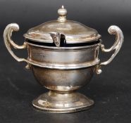 A silver hallmarked condiment pot in the