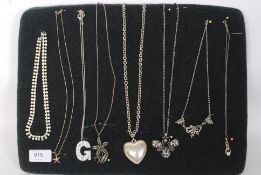 A collection of eight pendant necklaces