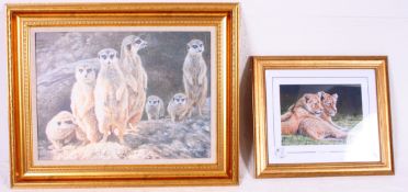 A framed picture of a Meercat family  al