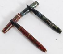 A mid century 14ct gold nib lever fill fountain pen in marble effect body marked made in England.