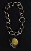An unusual white metal bracelet with inset ball agate moon stone having decorative banded centre.